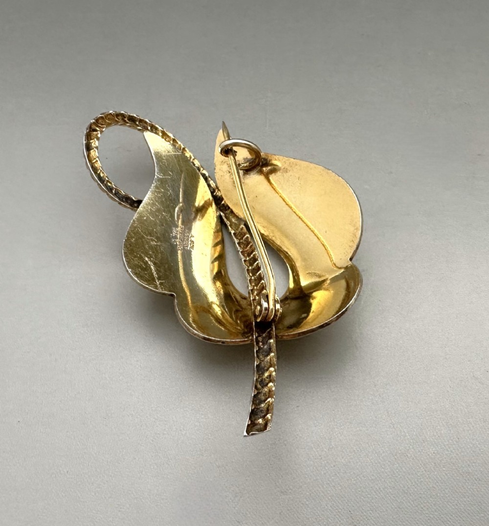 A leaf-shaped Norwegian silver gilt brooch featuring layered yellow guilloche enamel and twisted silver accents. View V