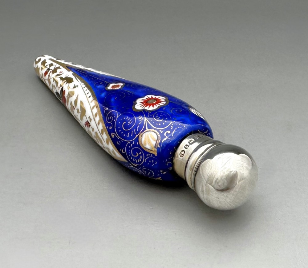 A Victorian teardrop-shaped porcelain scent bottle decorated with blue, red, and gold Imari motifs, featuring a silver spherical cap. View IV