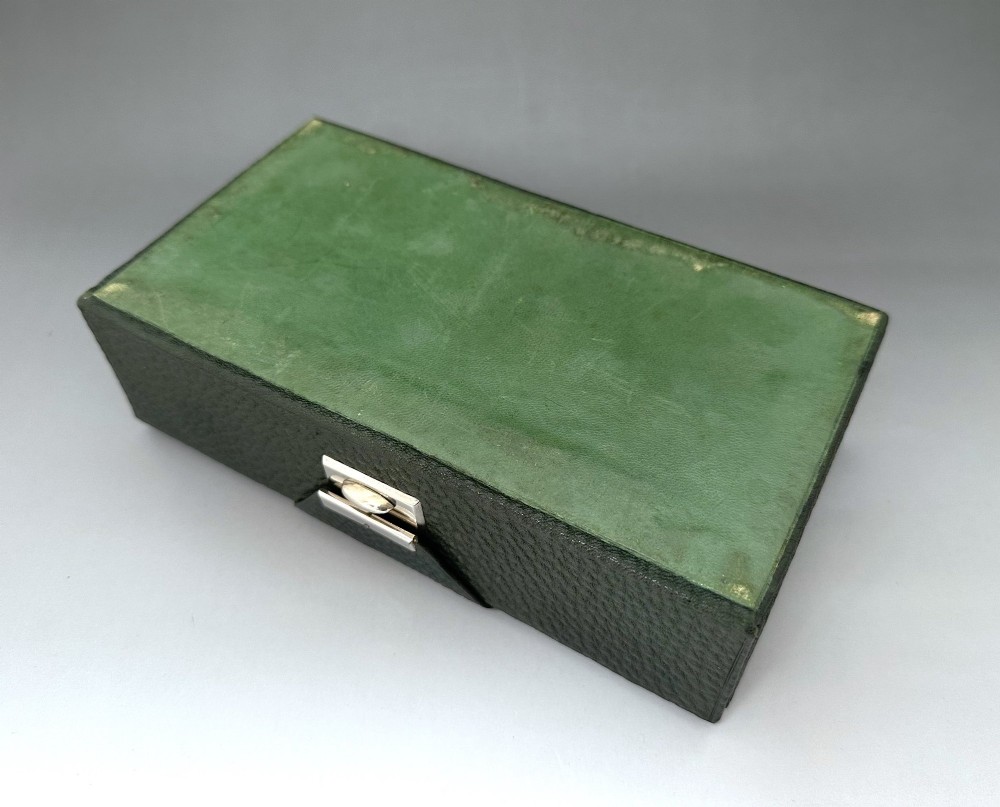 A dark green pebbled leather rectangular bridge box featuring applied silver script spelling Bridge on the top cover and a silver clasp closure. View XI