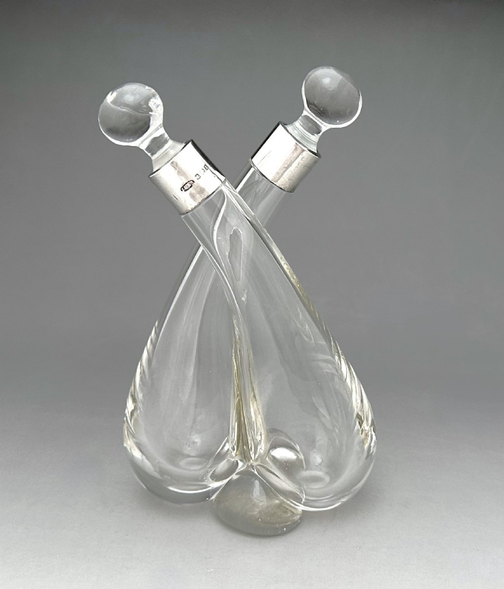 A George V silver mounted oil & vinegar duo