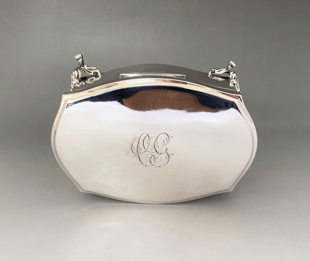 A silver jewellery trinket box with a hinged monogrammed lid supported on four decorative cabriole legs. View VII