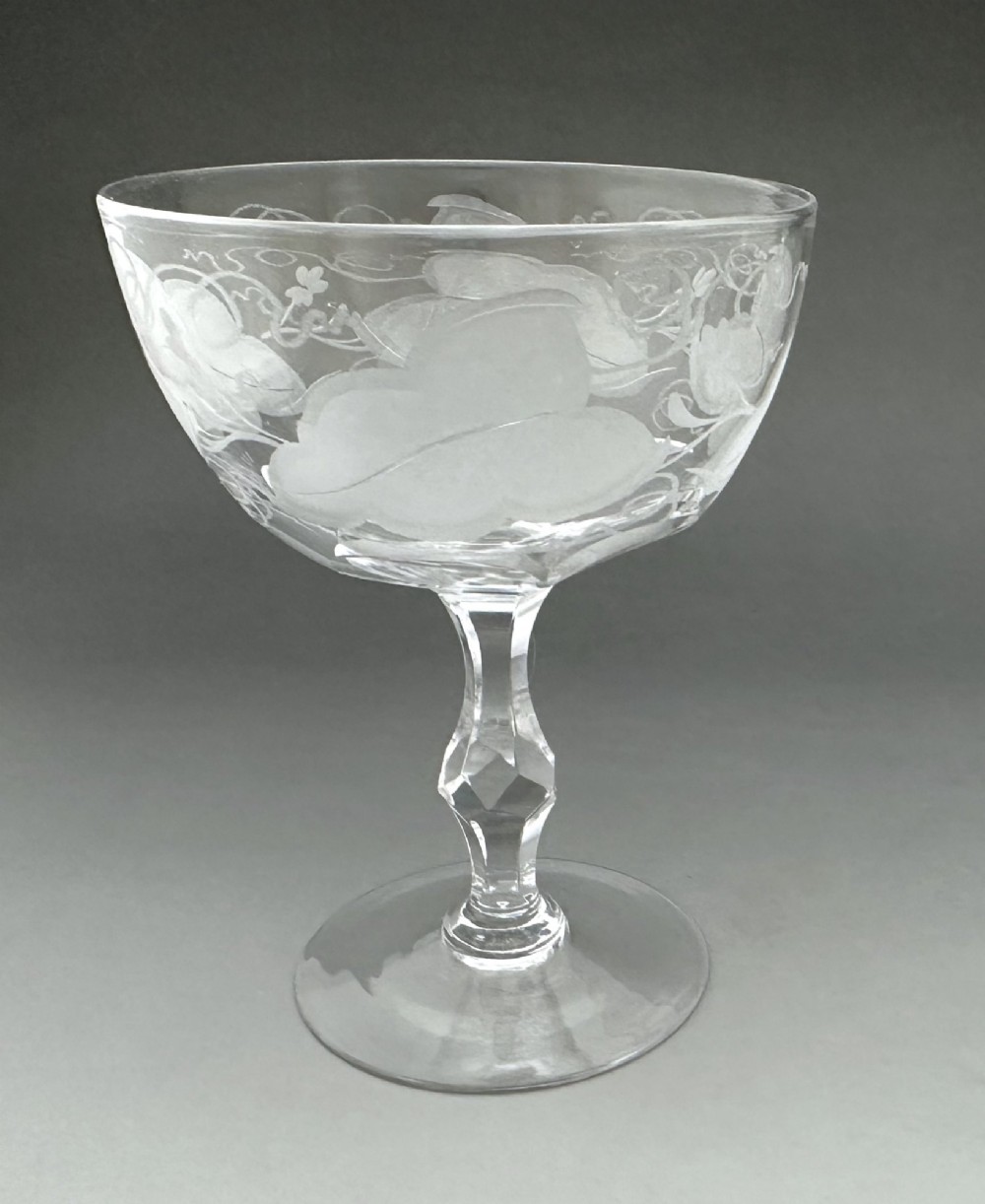A harlequin set of six antique clear glass champagne coupes featuring various hand-etched geometric and floral patterns. View VI