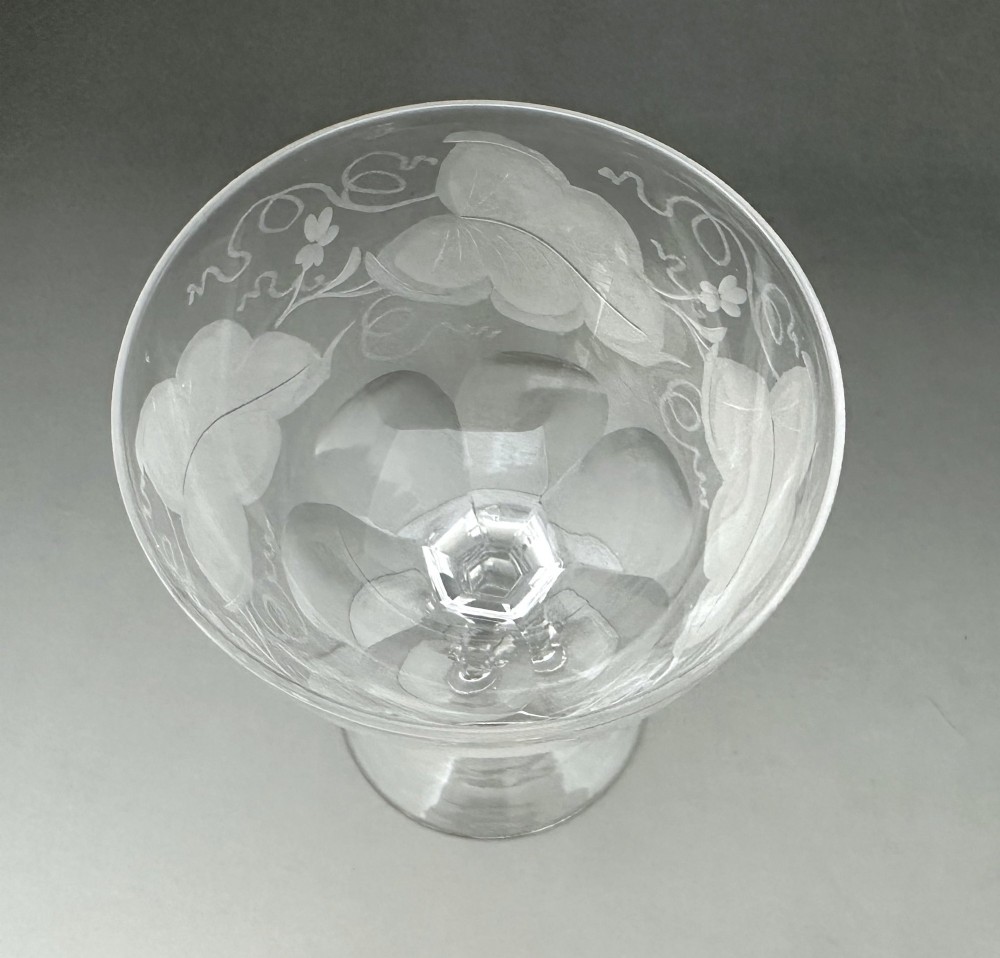 A harlequin set of six antique clear glass champagne coupes featuring various hand-etched geometric and floral patterns. View VII