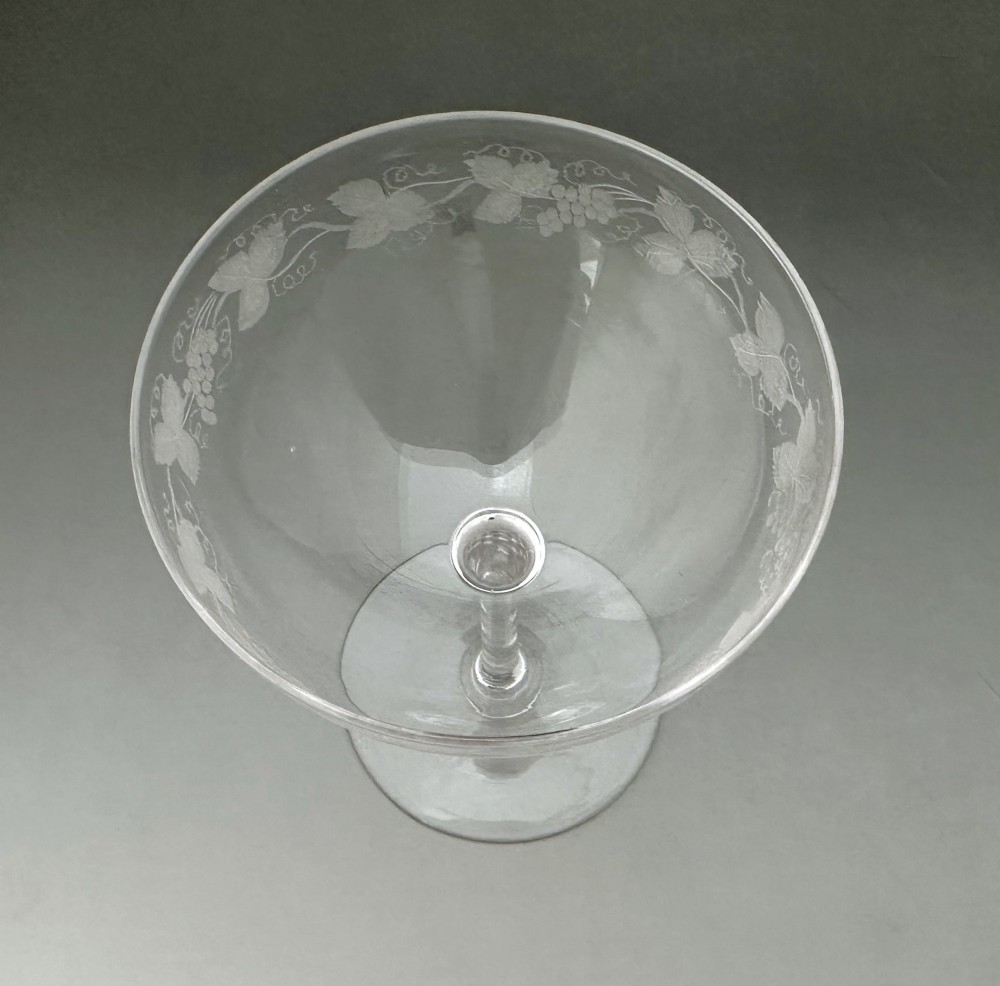 A harlequin set of six antique clear glass champagne coupes featuring various hand-etched geometric and floral patterns. View IX
