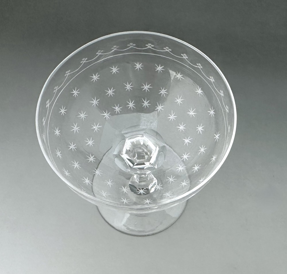 A harlequin set of six antique clear glass champagne coupes featuring various hand-etched geometric and floral patterns. View XI