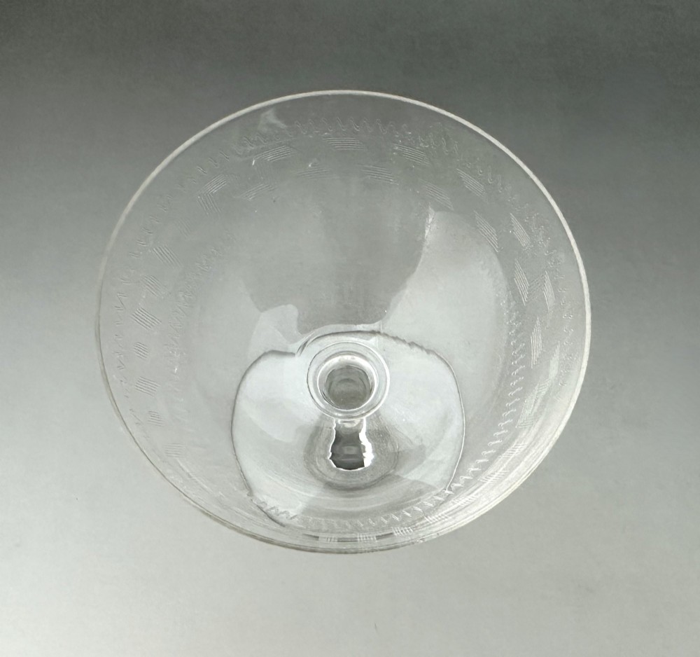 A harlequin set of six antique clear glass champagne coupes featuring various hand-etched geometric and floral patterns. View XIII