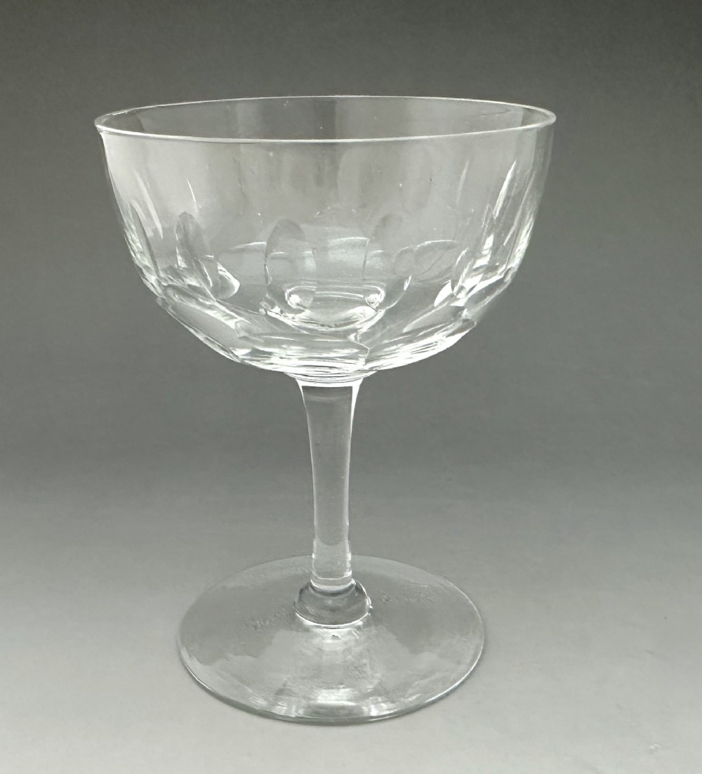 A harlequin set of six antique clear glass champagne coupes featuring various hand-etched geometric and floral patterns. View XIV