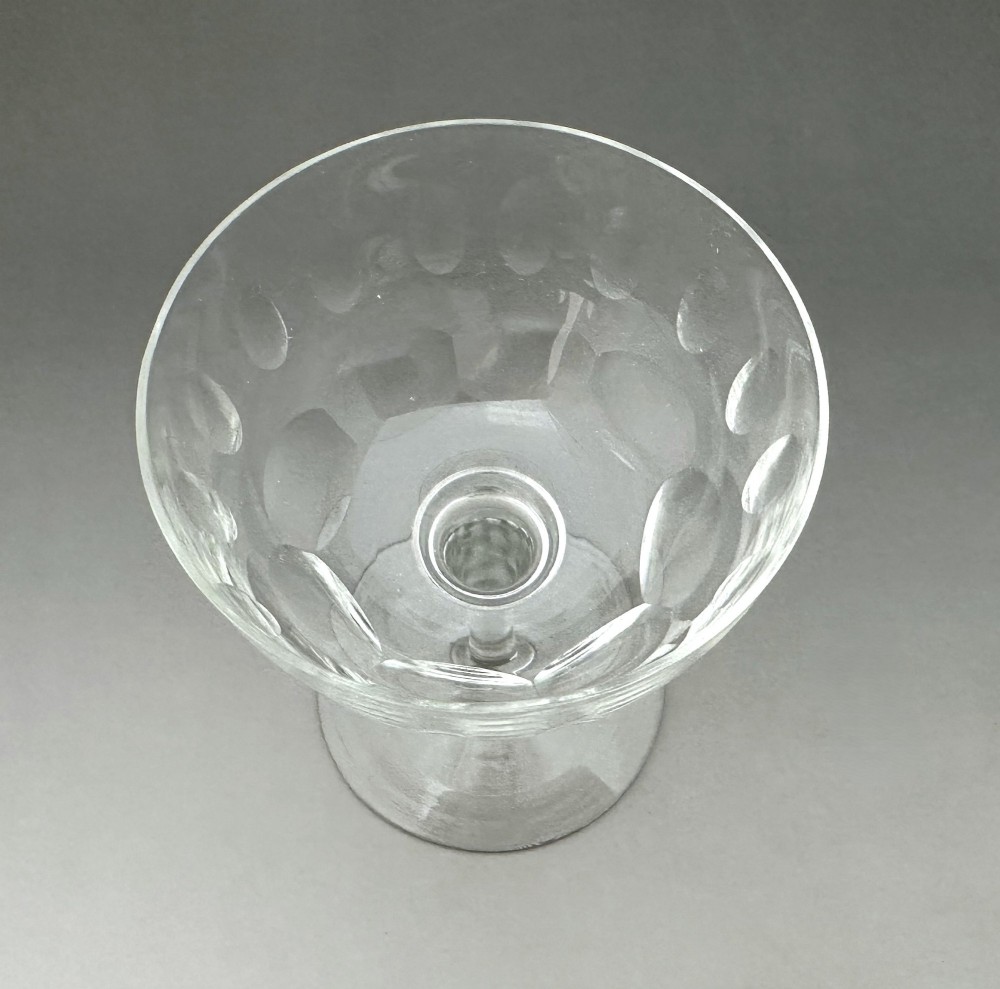 A harlequin set of six antique clear glass champagne coupes featuring various hand-etched geometric and floral patterns. View XV
