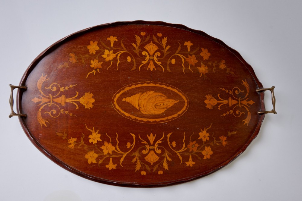 An oval mahogany serving tray featuring a scalloped rim, twin brass handles, floral marquetry, and a central inlaid shell motif. View II