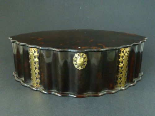 fig 1. An eighteenth-century lobed Dutch Colonial tortoiseshell casket featuring pierced silver-gilt strapwork mounts and an oval lock plate.