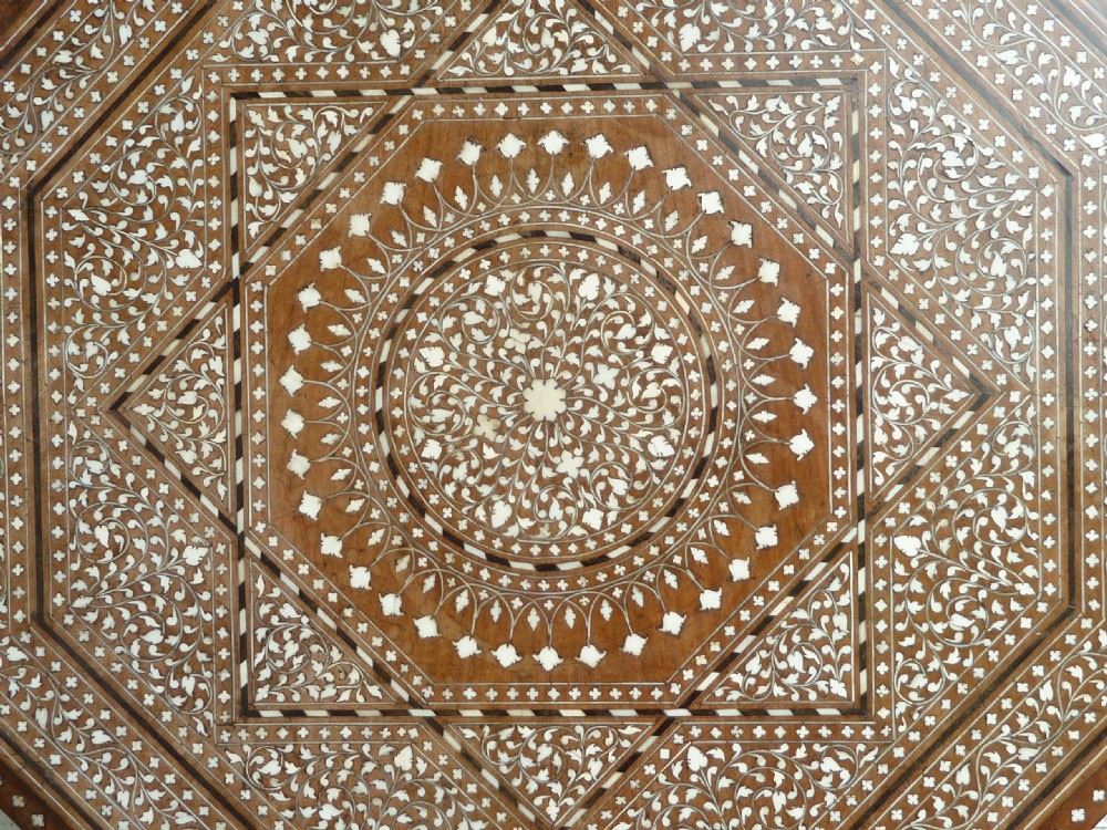 An Anglo-Indian octagonal wooden table featuring intricate bone inlay with geometric and floral motifs above Moorish arched lower aprons. View V