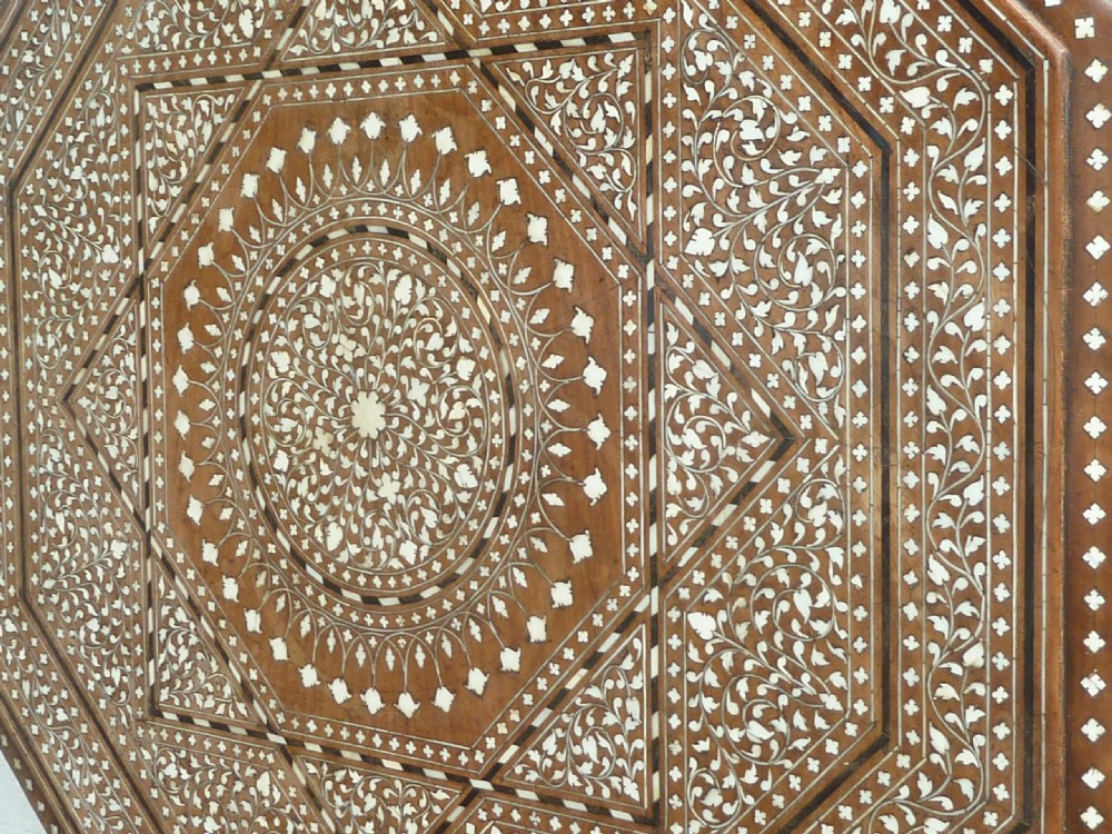 An Anglo-Indian octagonal wooden table featuring intricate bone inlay with geometric and floral motifs above Moorish arched lower aprons. View VI