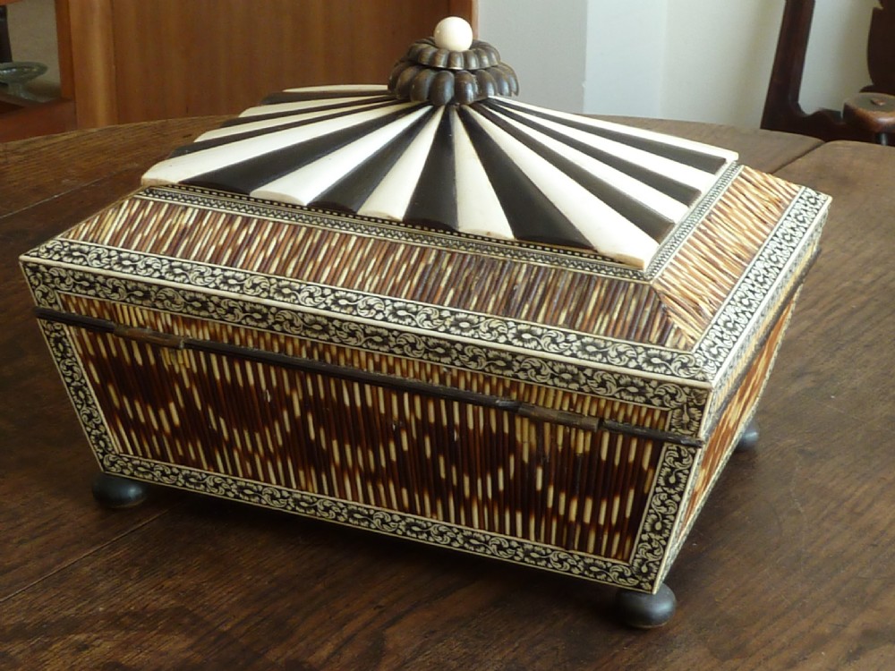 An Anglo-Indian sarcophagus-form workbox featuring porcupine quill panels, engraved bone borders, and a sunburst horn and bone lid finial. View II