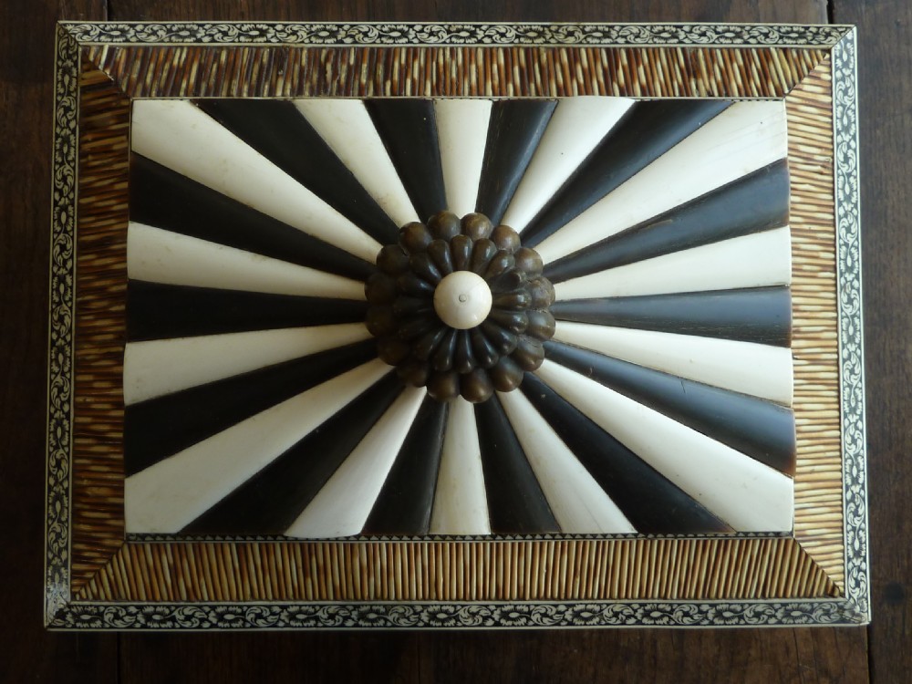 An Anglo-Indian sarcophagus-form workbox featuring porcupine quill panels, engraved bone borders, and a sunburst horn and bone lid finial. View III