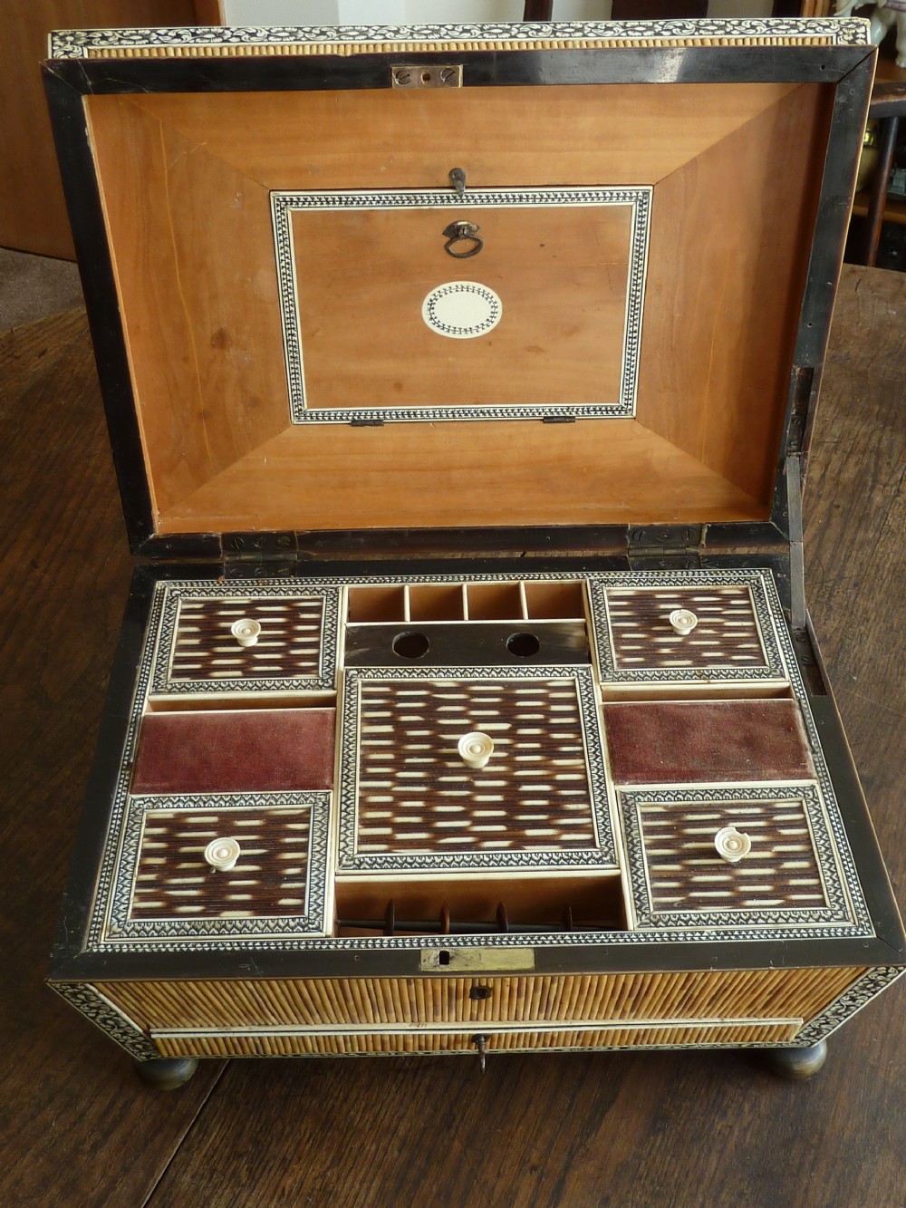 An Anglo-Indian sarcophagus-form workbox featuring porcupine quill panels, engraved bone borders, and a sunburst horn and bone lid finial. View IV
