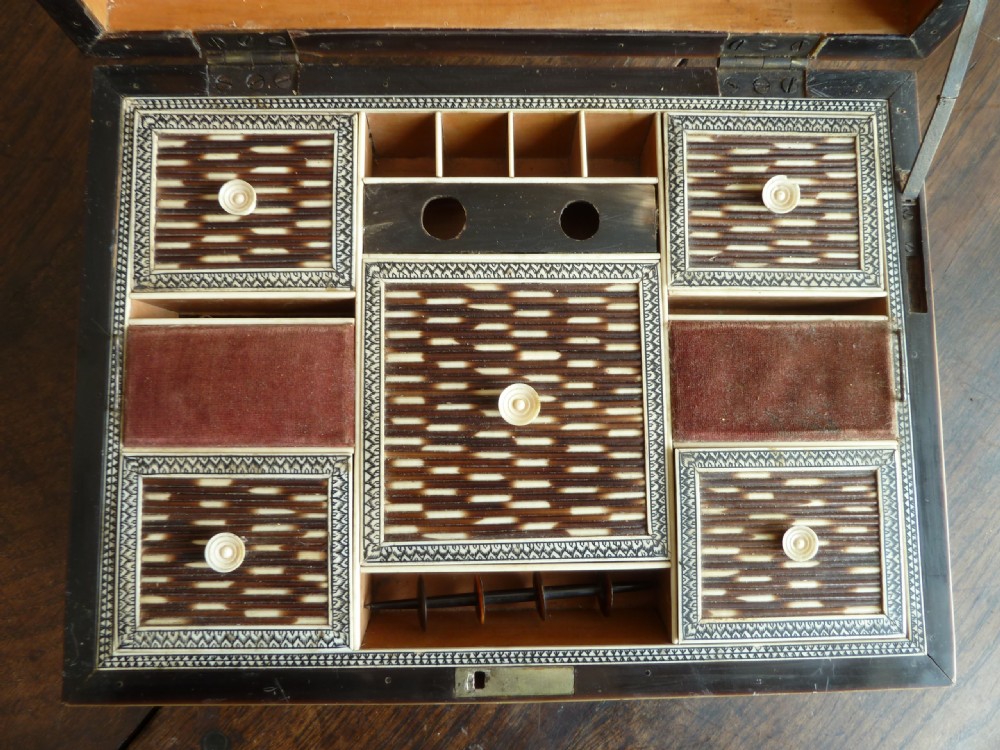 An Anglo-Indian sarcophagus-form workbox featuring porcupine quill panels, engraved bone borders, and a sunburst horn and bone lid finial. View VIII