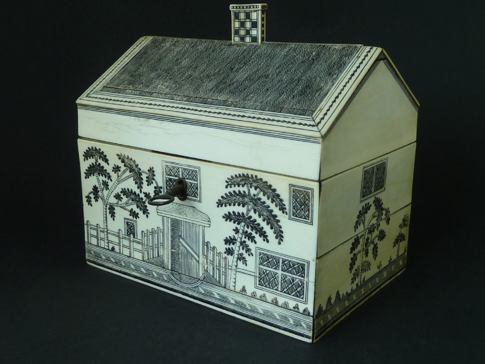 A house-shaped antique Anglo-Indian sewing box clad in ivory panels with black lac-engraved architectural details, trees, and a pitched roof. View II