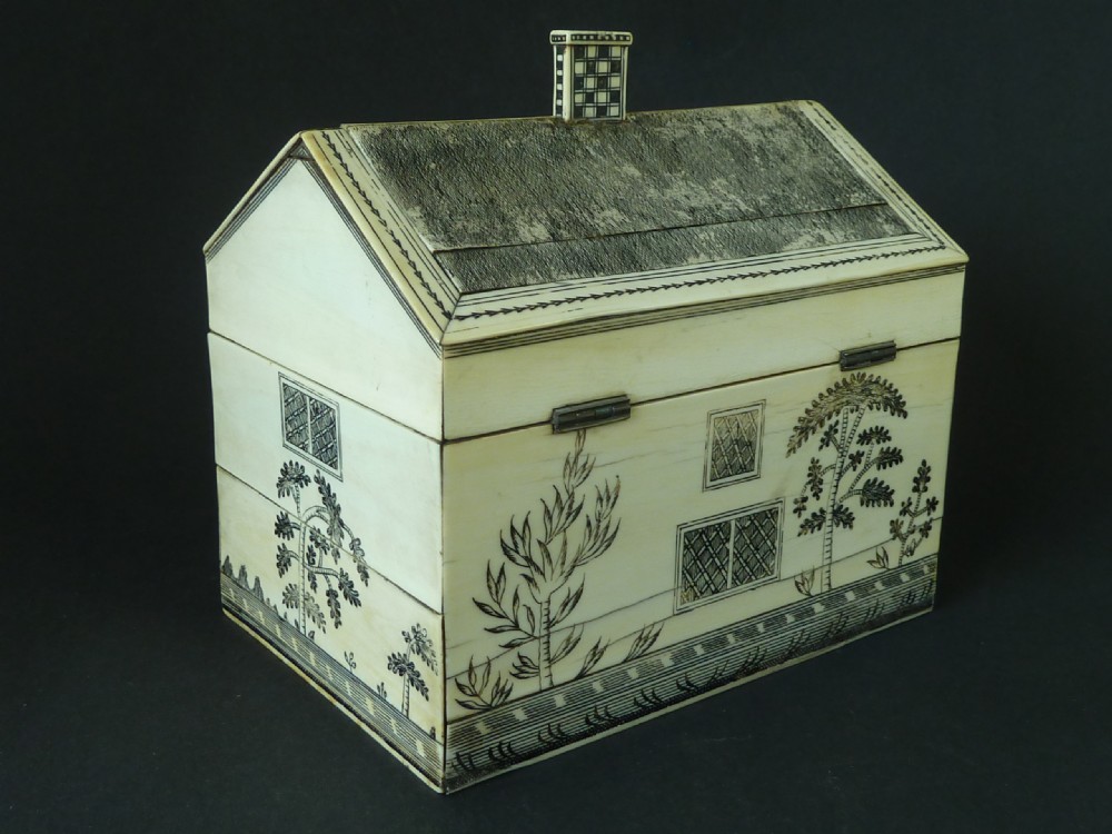 A house-shaped antique Anglo-Indian sewing box clad in ivory panels with black lac-engraved architectural details, trees, and a pitched roof. View III