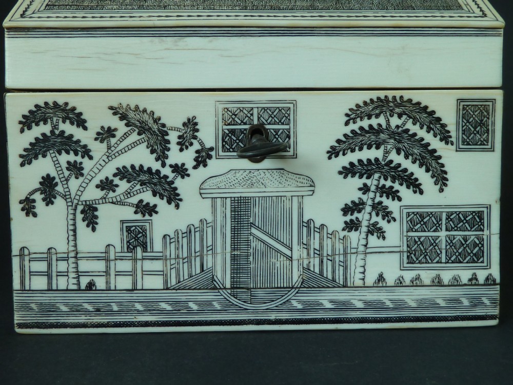 A house-shaped antique Anglo-Indian sewing box clad in ivory panels with black lac-engraved architectural details, trees, and a pitched roof. View V