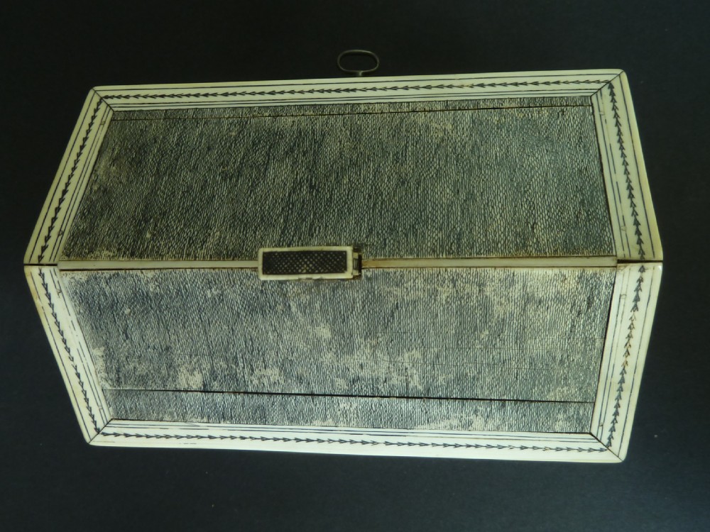 A house-shaped antique Anglo-Indian sewing box clad in ivory panels with black lac-engraved architectural details, trees, and a pitched roof. View VI
