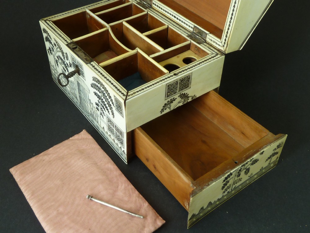 A house-shaped antique Anglo-Indian sewing box clad in ivory panels with black lac-engraved architectural details, trees, and a pitched roof. View IX