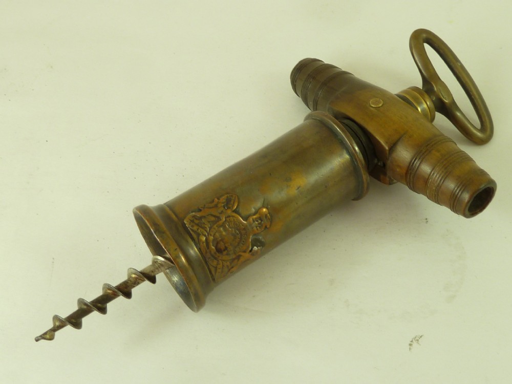 A Georgian patinated bronze Thomason patent mechanical corkscrew featuring a Royal Coat of Arms crest badge and steel helix.