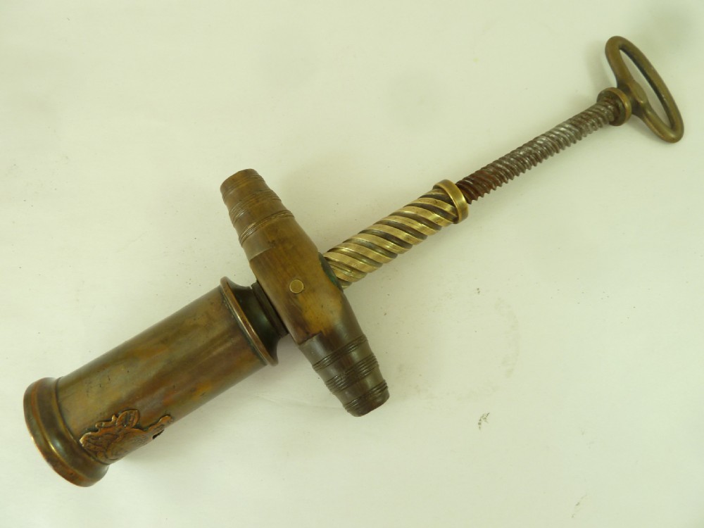 A Georgian patinated bronze Thomason patent mechanical corkscrew featuring a Royal Coat of Arms crest badge and steel helix. View V