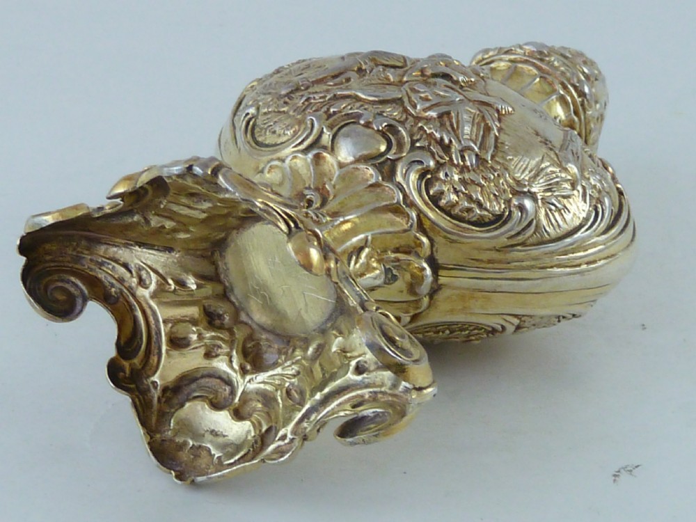 A Hanau silver gilt sugar caster featuring elaborate Rococo relief scenes of figures in a landscape and a pierced finial lid. View VIII