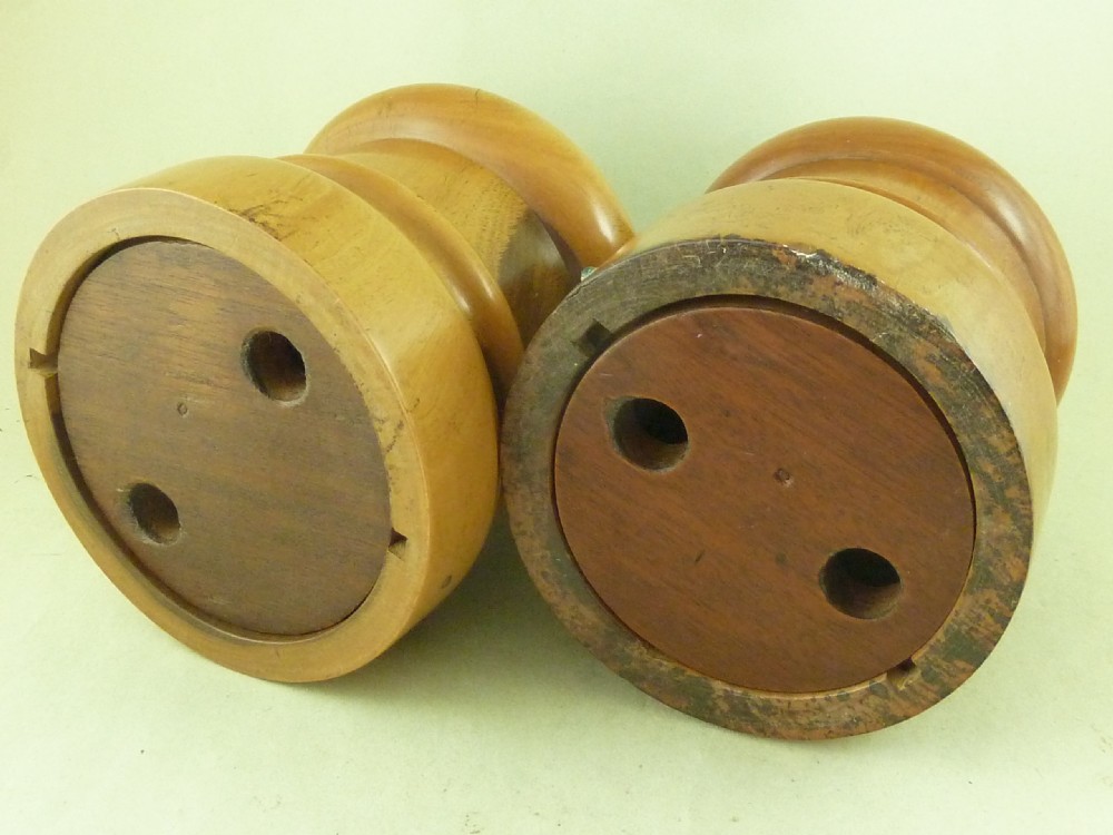 A near pair of turned lignum vitae wooden string holders with cylindrical barrels and rounded tops. View IV