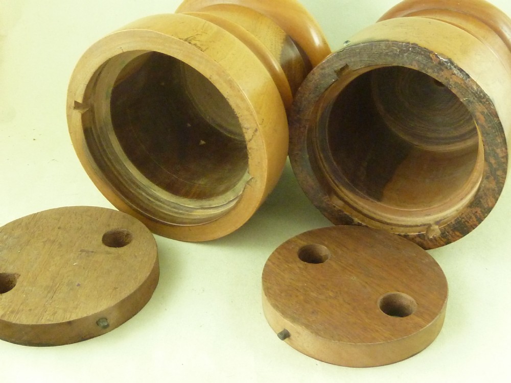 A near pair of turned lignum vitae wooden string holders with cylindrical barrels and rounded tops. View V