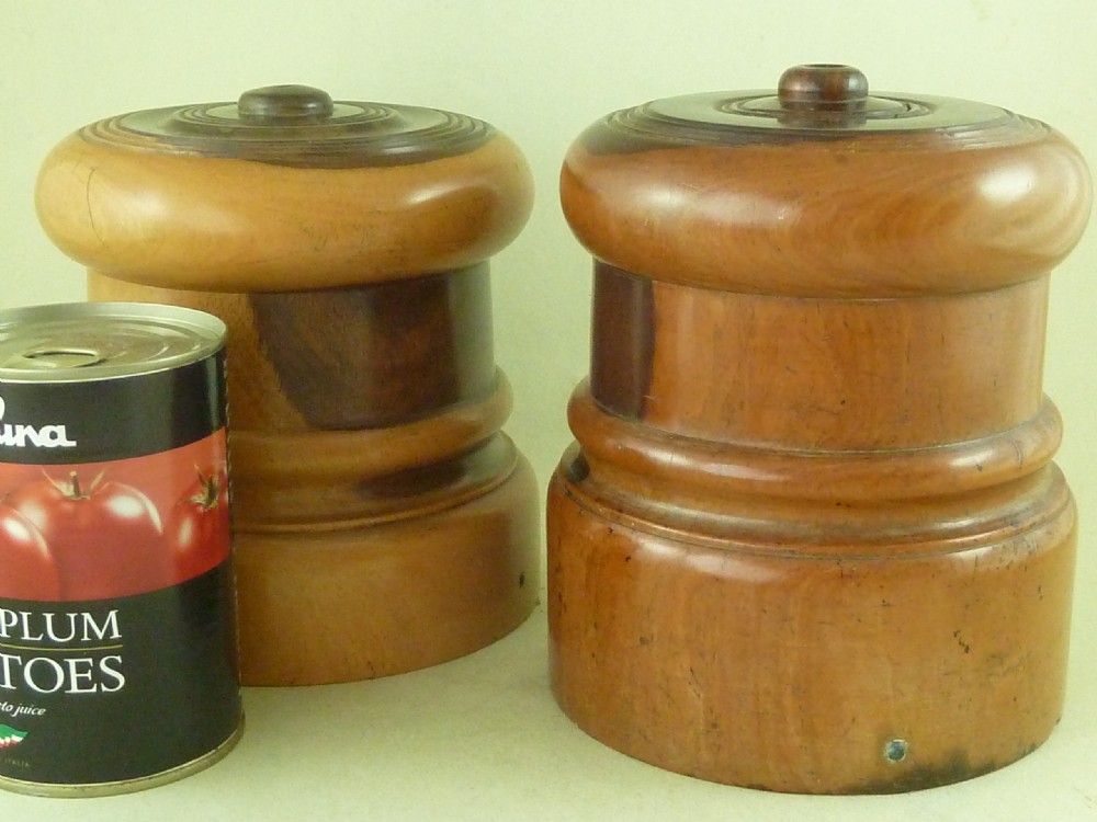 A near pair of turned lignum vitae wooden string holders with cylindrical barrels and rounded tops. View VII
