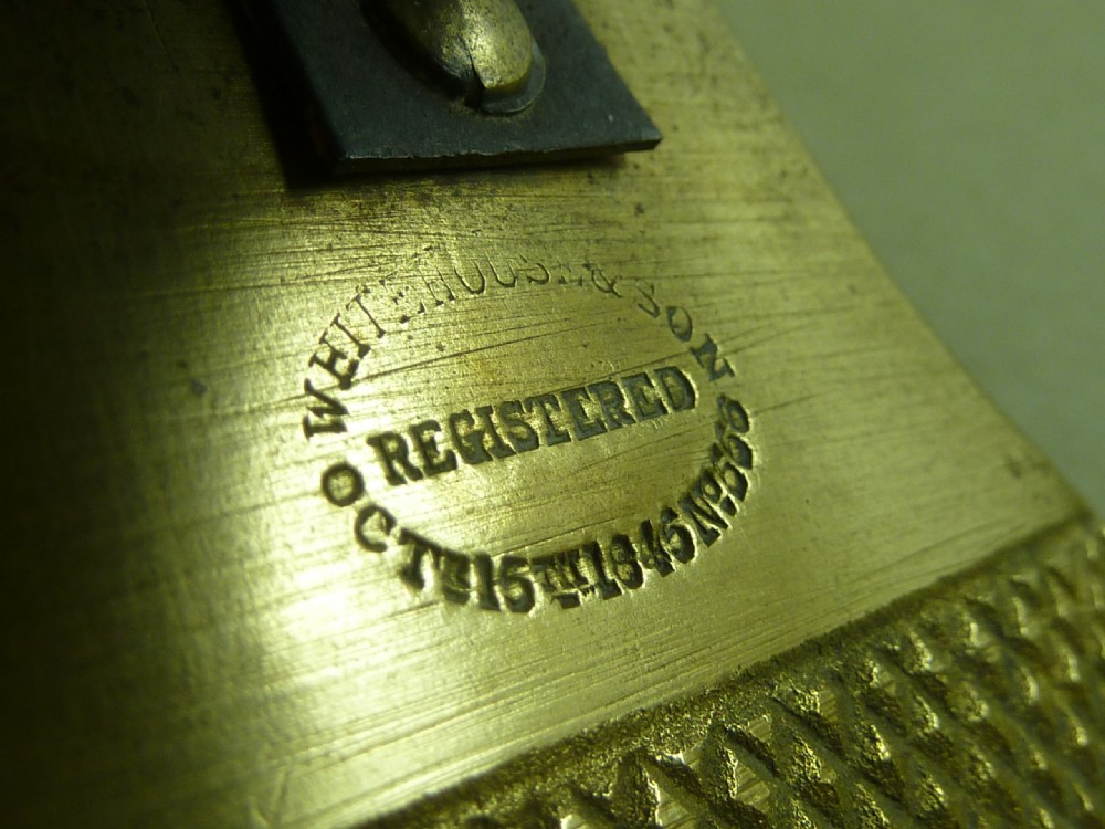 Victorian heavy cast brass letter clip decorated with relief carvings of agricultural tools, wheat sheaves, and barrels. View V