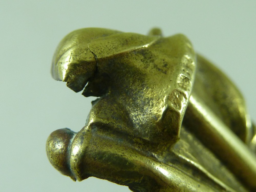Victorian heavy cast brass letter clip decorated with relief carvings of agricultural tools, wheat sheaves, and barrels. View VII