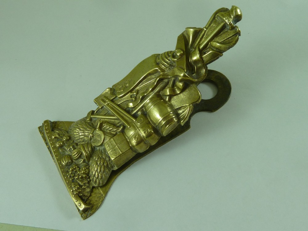 Victorian heavy cast brass letter clip decorated with relief carvings of agricultural tools, wheat sheaves, and barrels. View IX