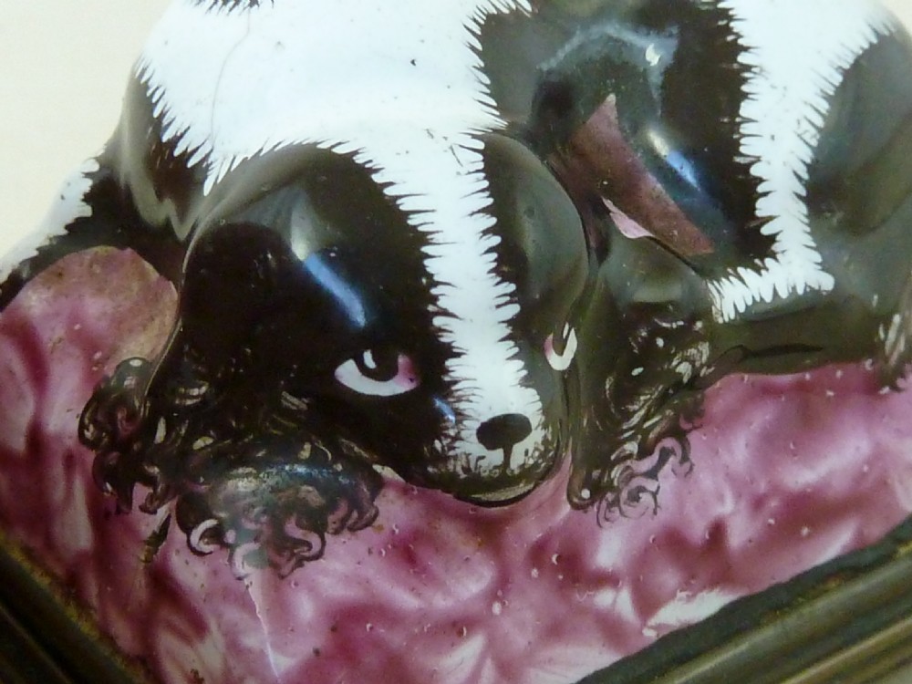 An eighteenth-century Bilston enamel snuff box depicting a black and white King Charles spaniel curled on a magenta cushion base with metal mounts. View VII