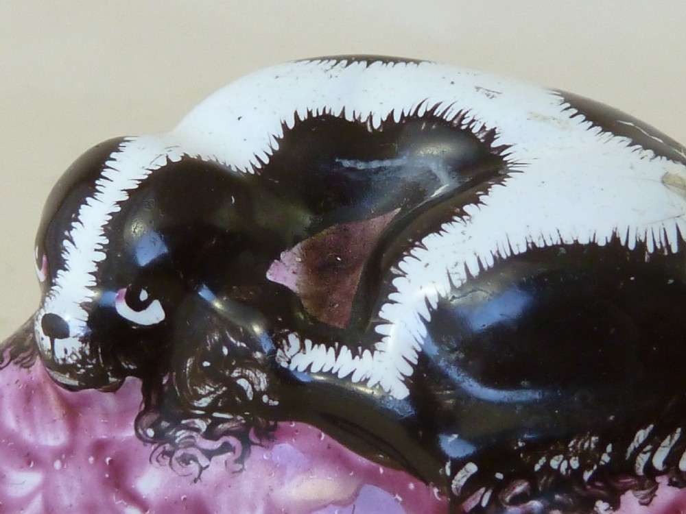 An eighteenth-century Bilston enamel snuff box depicting a black and white King Charles spaniel curled on a magenta cushion base with metal mounts. View VIII