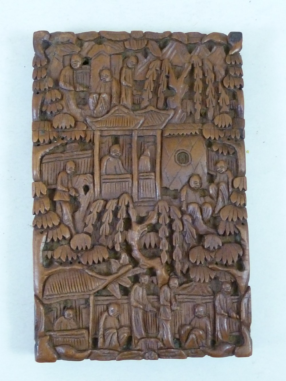 A rectangular nineteenth-century Chinese sandalwood visiting card case featuring high-relief relief carvings of figures, pavilions, and trees. View II