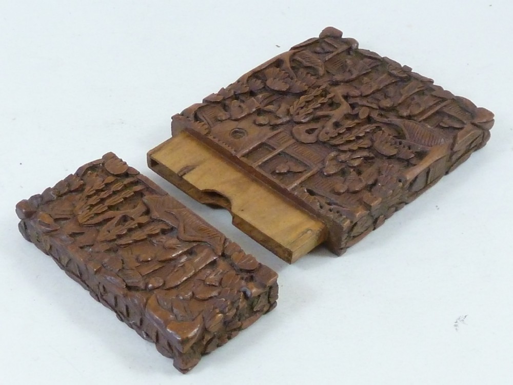 A rectangular nineteenth-century Chinese sandalwood visiting card case featuring high-relief relief carvings of figures, pavilions, and trees. View V