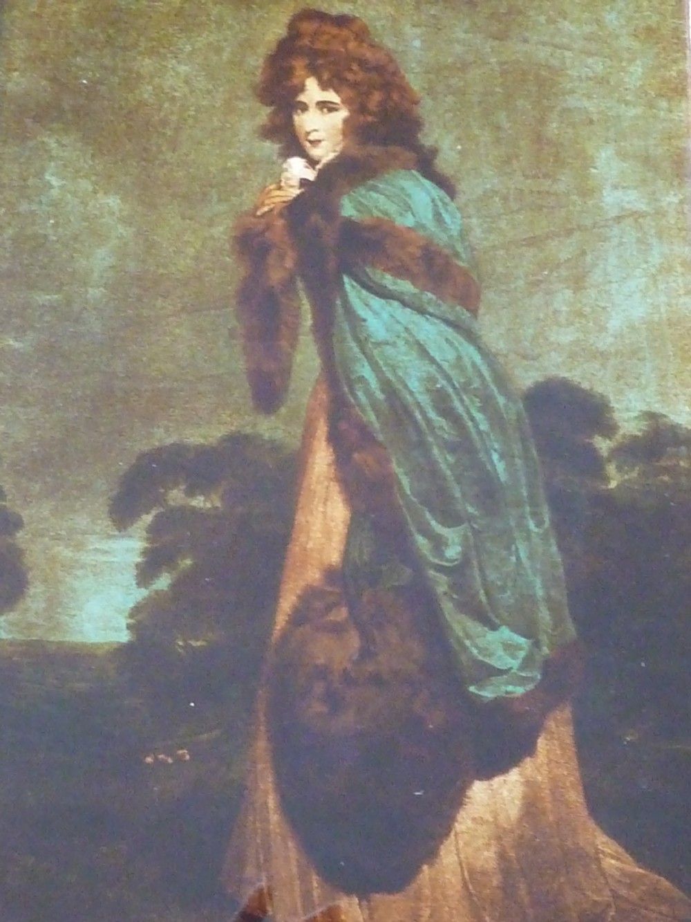 A Georgian reverse glass painted print depicting Elizabeth Farren wearing a green fur-trimmed cloak, set in a dark moulded wooden frame with a gilt inner border. View III