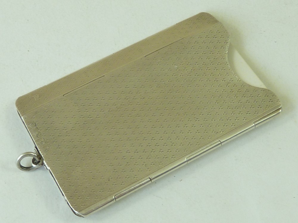An Art Deco solid silver folding card case featuring engine-turned wave engraving and an engraved initial plaque. View II