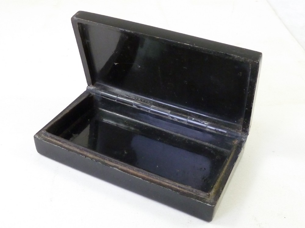 A rectangular dark pressed horn snuff box featuring a relief moulding of Napoleons funeral procession on the lid. View IV