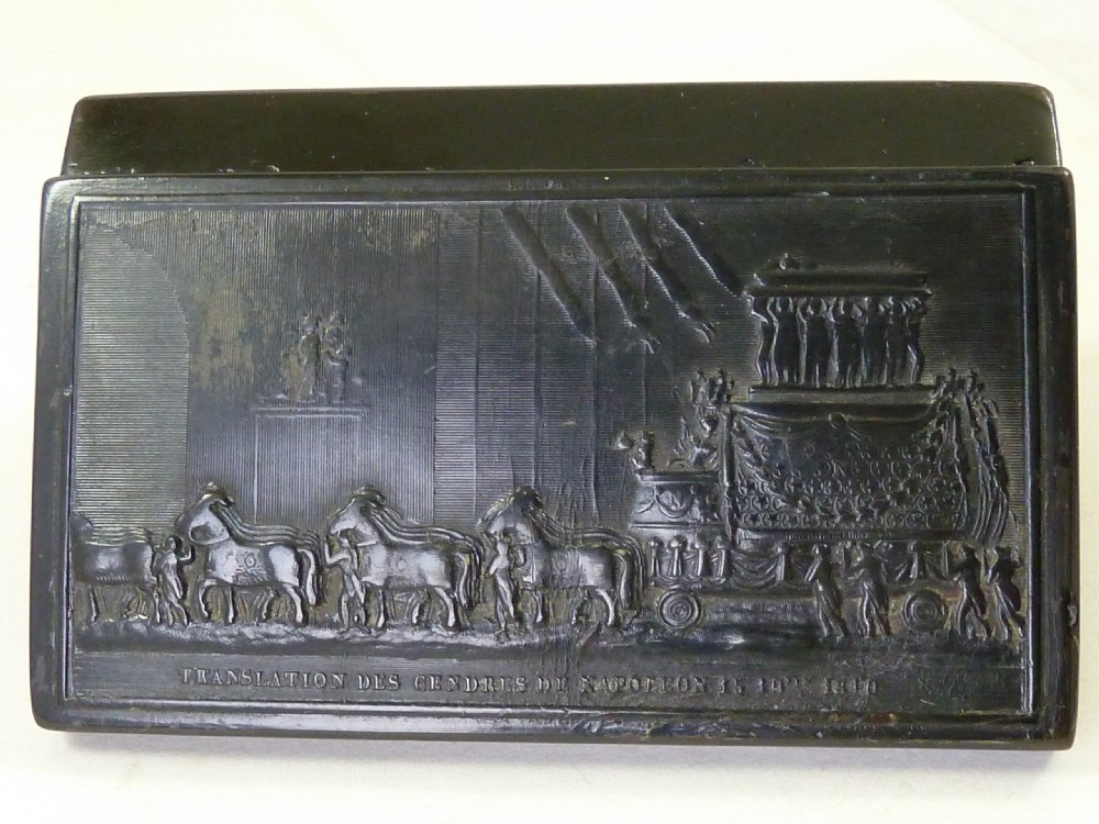 A rectangular dark pressed horn snuff box featuring a relief moulding of Napoleons funeral procession on the lid. View V