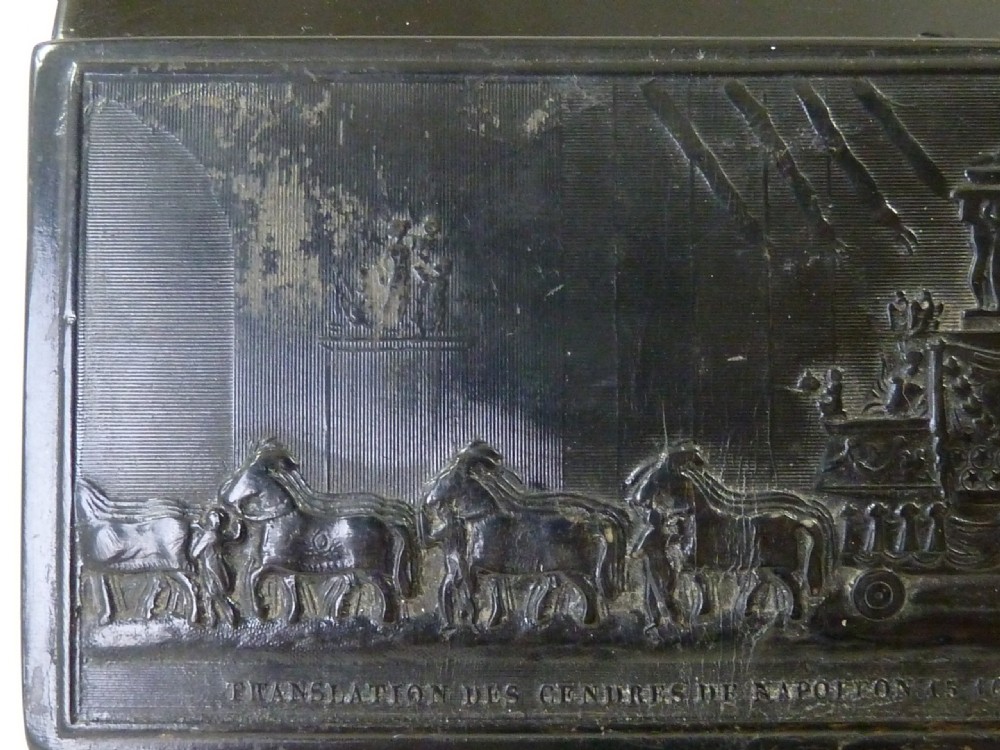 A rectangular dark pressed horn snuff box featuring a relief moulding of Napoleons funeral procession on the lid. View VII