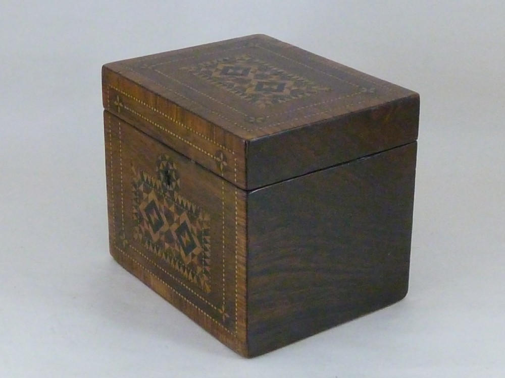 A Victorian rosewood tea caddy featuring intricate geometric wooden mosaic inlay on the lid and front panel. View IV