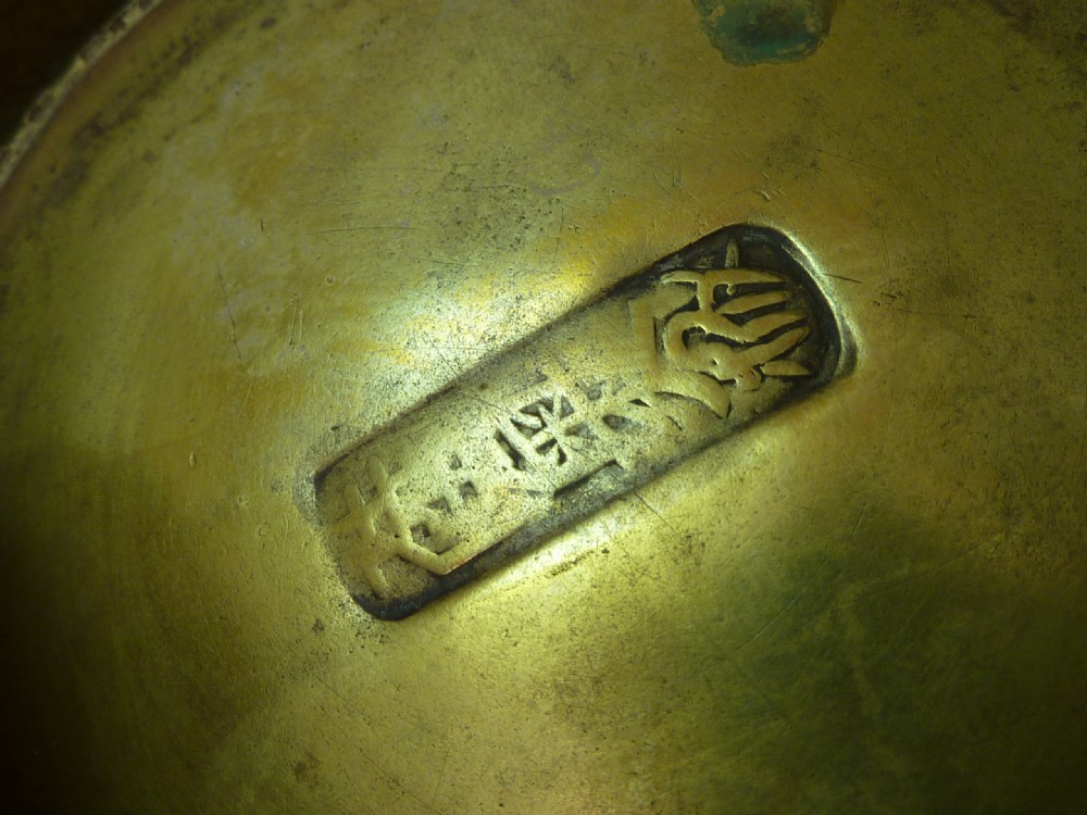 A solid brass Tibetan butter lamp displaying a flared circular base, knopped stem, and wide shallow rimmed upper bowl. View II
