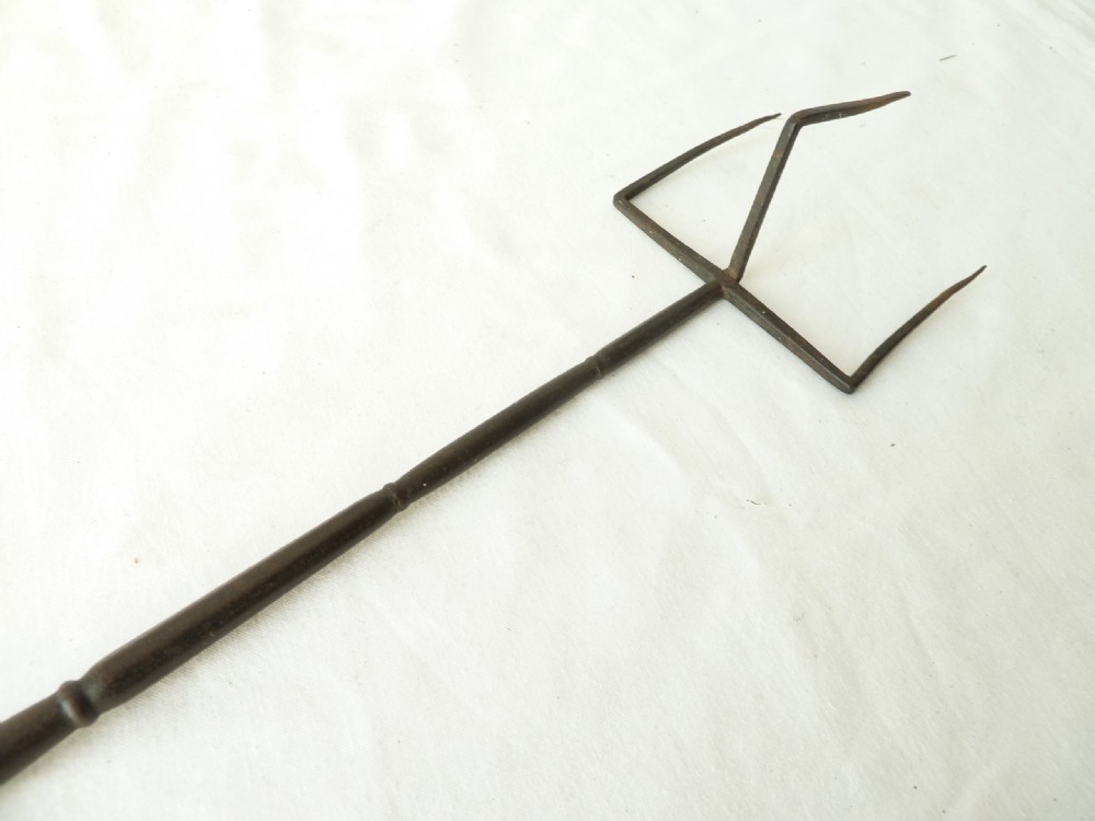 A long Georgian wrought iron toasting fork featuring a three-pronged head and a turned yew wood handle. View VII