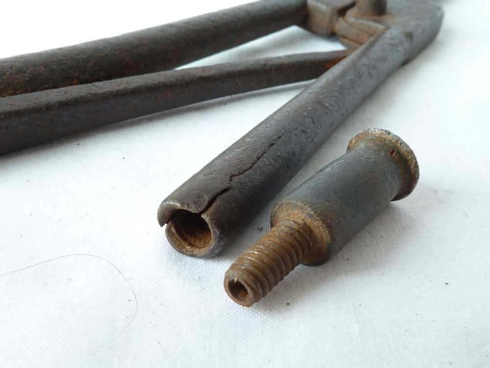 A pair of hand-forged Georgian dark steel ember tongs with elongated jaws and a spring handle mechanism. View X