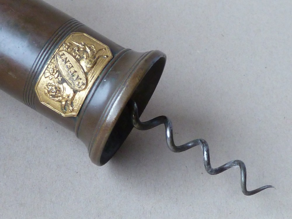 An antique dark bronze Thomason patent corkscrew featuring a turned bone handle, side key, detachable bristle brush, and an applied brass crest. View VII