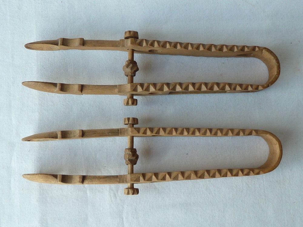 A pair of hand-carved Victorian Welsh wooden sugar tongs with serrated edges, heart cutouts, turned knobs, and inset name plates reading Miss Williams. View IV