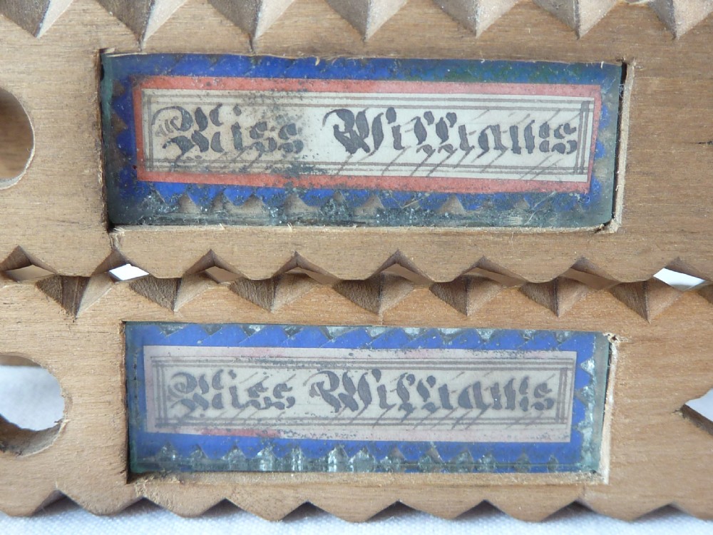 A pair of hand-carved Victorian Welsh wooden sugar tongs with serrated edges, heart cutouts, turned knobs, and inset name plates reading Miss Williams. View VII